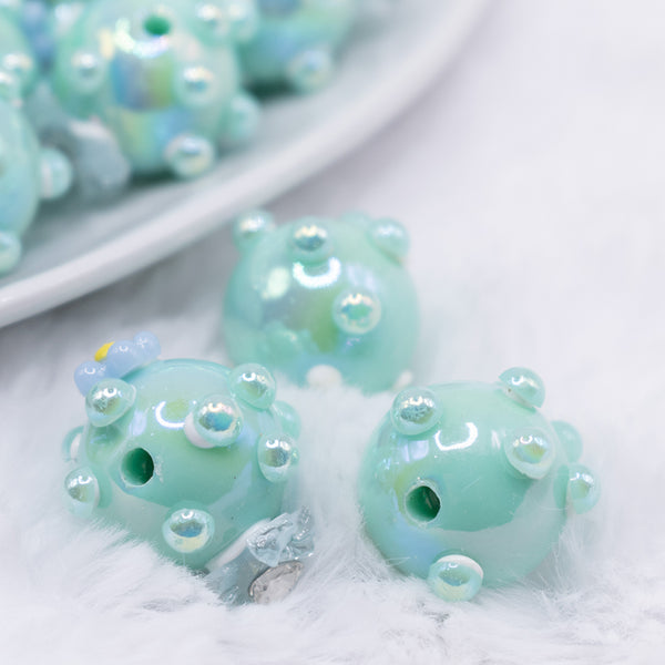 close up view of a pile of 16mm Teal with Blue Flowers luxury acrylic beads