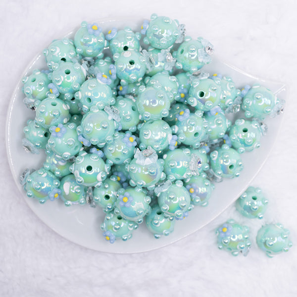 top view of a pile of 16mm Teal with Blue Flowers luxury acrylic beads
