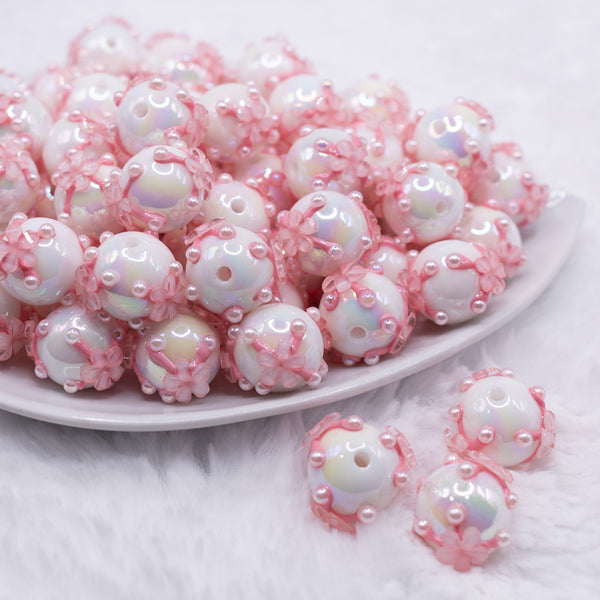 front view of a pile of 16mm White with Pink Flowers luxury acrylic beads