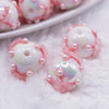 close up view of a pile of 16mm White with Pink Flowers luxury acrylic beads
