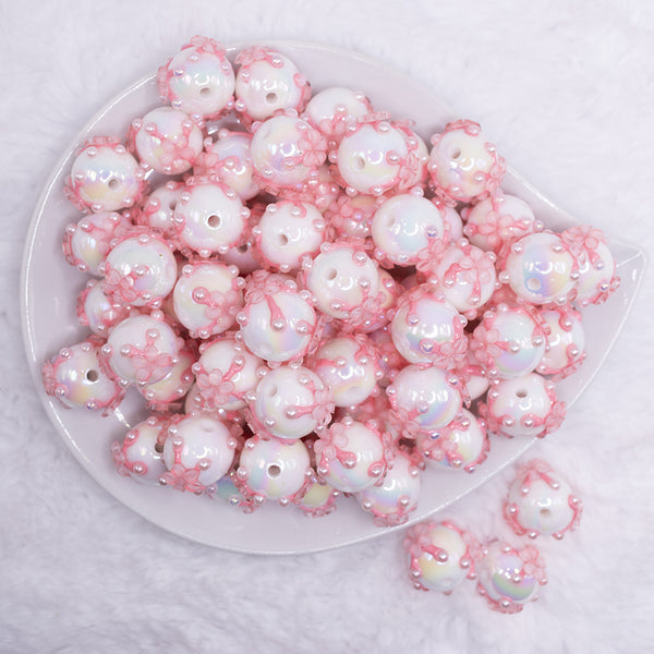 top view of a pile of 16mm White with Pink Flowers luxury acrylic beads