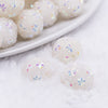 Close up view of a pile of 16mm White Snowflake luxury acrylic beads