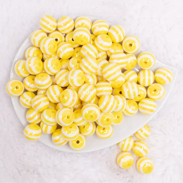 top view of a pile of 16MM Yellow with AB Stripes Bubblegum Beads