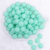top view of a pile of 16mm Aqua with Clear Rhinestone Bubblegum Beads