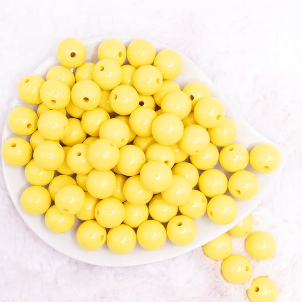 top view of a pile of 16mm Yellow Solid Bubblegum Beads