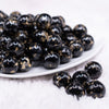 front view of a pile of16mm Black with Gold Flake Acrylic Chunky Bubblegum Beads