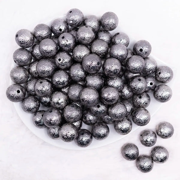 top view of a pile of 16mm Black Crinkle Foil Bubblegum Beads