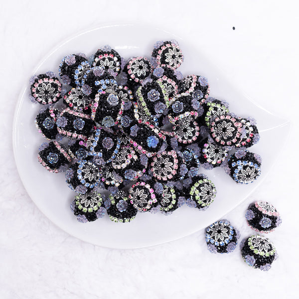 top view of a pile of 20mm Black luxury acrylic beads with iridescent flower accents