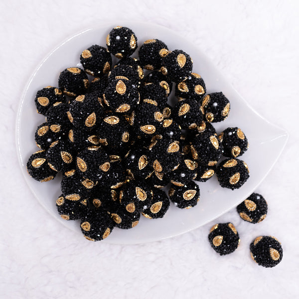 top view of a pile of 16mm Black with Gold Paisley luxury acrylic beads