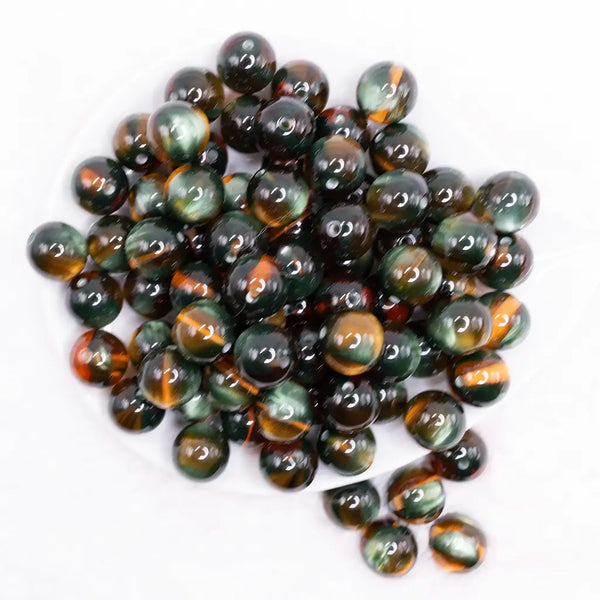 top view of a pile of 16mm Cats Eye Black and Green Illusion Glitter Bubblegum Bead