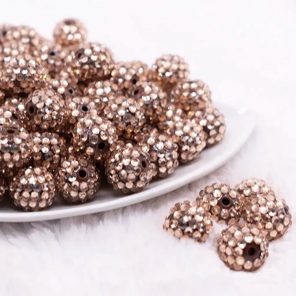 front view of a pile of 16mm Champagne Gold Rhinestone on Brown Bubblegum Bead