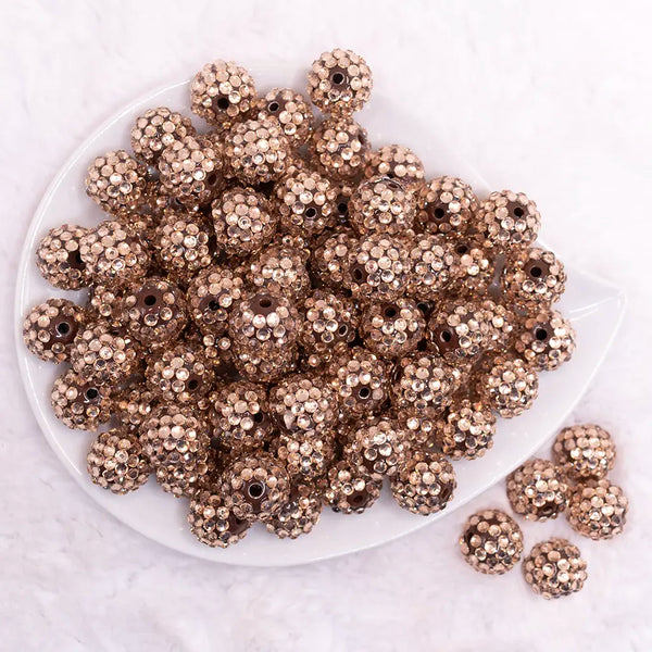top view of a pile of 16mm Champagne Gold Rhinestone on Brown Bubblegum Bead