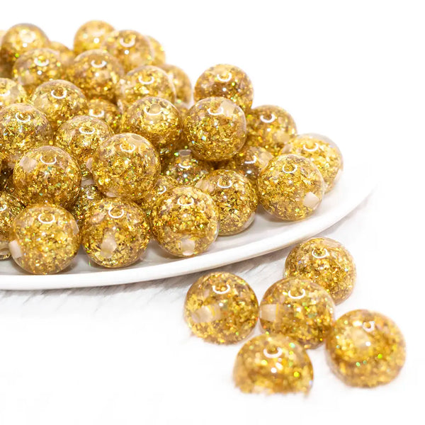 front view of a pile of 16mm Gold Glitter Twinkle Bubblegum Beads
