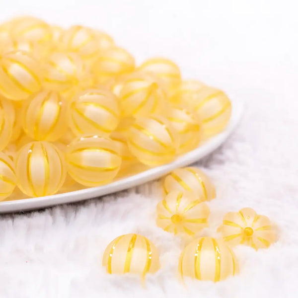front view of a pile of 16mm Golden Yellow Frosted Pumpkin Shaped Bubblegum Bead