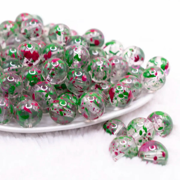 front view of a pile of 16mm Green and Hot Pink Splatter Bubblegum Bead