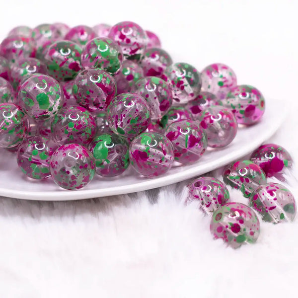 front view of a pile of 16mm Green and Purple Splatter Bubblegum Bead