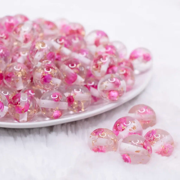 front view of a pile of 16mm Hot Pink Flaked Flower Bubblegum Bead
