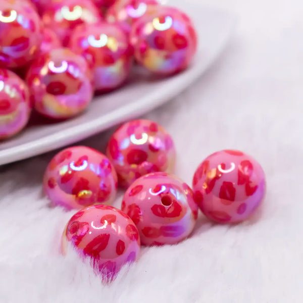 close up view of a pile of 16mm Red Lips AB Print on Hot Pink bubblegum bead