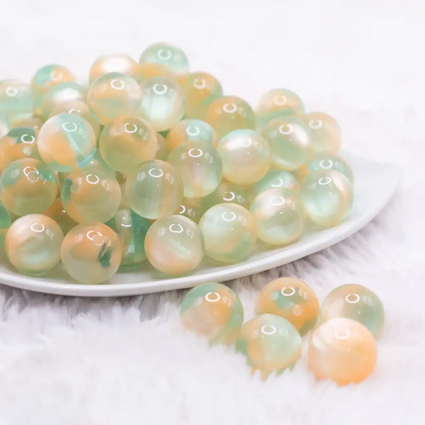 front view of a pile of 16mm Light Green Illusion Glitter Bubblegum Bead