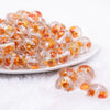 front view of a pile of 16mm Orange Flaked Flower Bubblegum Bead