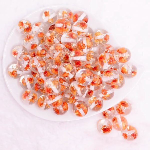 top view of a pile of 16mm Orange Flaked Flower Bubblegum Bead