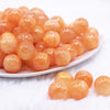 front view of a pile of 16mm Orange Luster Bubblegum Beads