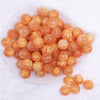 top view of a pile of 16mm Orange Luster Bubblegum Beads