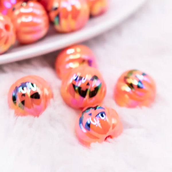 top view of a pile of 16mm Pumpkin Face on Orange AB Bubblegum Beads