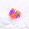 top view of a pile of 16mm Square Spider web print on Orange AB Bubblegum Beads