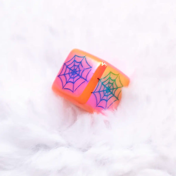 top view of a pile of 16mm Square Spider web print on Orange AB Bubblegum Beads