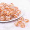 front view of a pile of 16mm Peach Cats Eye Acrylic Bubblegum Beads