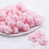 front view of a pile of 16mm Pink Floral Bliss luxury acrylic beads