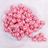 top view of a pile of 16mm Red Lips AB Print on Pink bubblegum bead