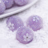 close up view of a pile of 16mm Purple with White Flowers luxury acrylic beads
