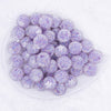 top view of a pile of 16mm Purple with White Flowers luxury acrylic beads