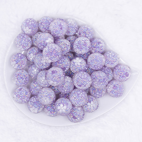 top view of a pile of 16mm Purple with White Flowers luxury acrylic beads