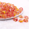 front view of a pile of 16mm Red and Yellow Splatter Bubblegum Bead