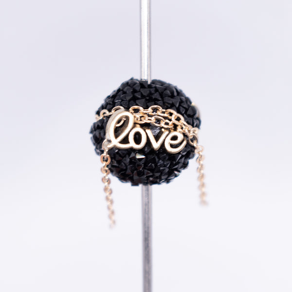 inspiration view of a pile of 16mm Gold Love on Black luxury acrylic beads