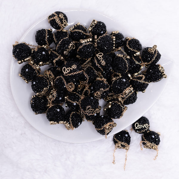 top view of a pile of 16mm Gold Love on Black luxury acrylic beads