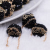 Close up view of a pile of 16mm Gold Love on Black luxury acrylic beads