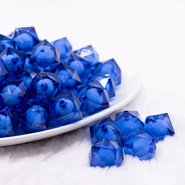 front view of a pile of 16mm Royal Blue Transparent Cube with Middle Bubblegum Beads