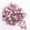 top view of a pile of 16mm Tea Rose Illusion Glitter Bubblegum Bead