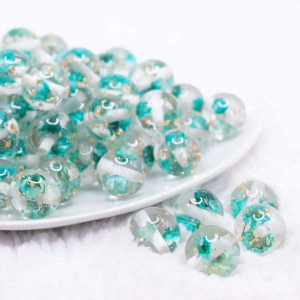 front view of a pile of 16mm Teal Blue Flaked Flower Bubblegum Bead