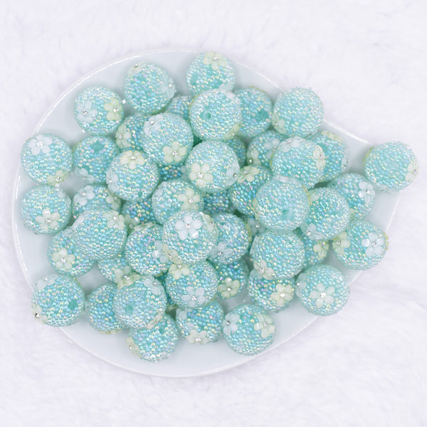 top view of a pile of 16mm Teal with Flowers luxury acrylic beads