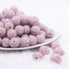 front view of a pile of 16mm Thistle Purple Rhinestone AB Bubblegum Beads