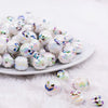 front. view of a pile of 16mm Pumpkin Face on White AB Bubblegum Beads