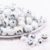 front view of a pile of 16mm Skeleton Face on White AB Bubblegum Beads