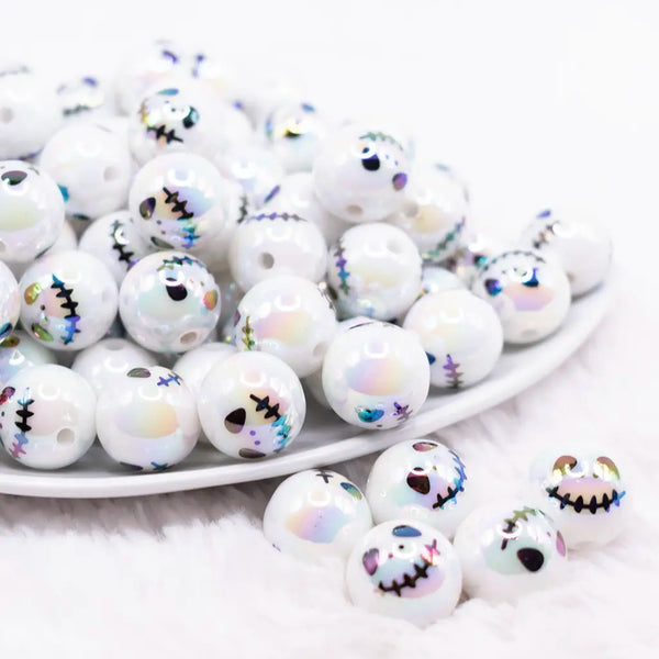 front view of a pile of 16mm Skeleton Face on White AB Bubblegum Beads