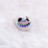 macro view of a pile of 16mm Skeleton Face on White AB Bubblegum Beads