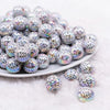 front view of a pile of 16mm White with Black Spiderweb AB Bubblegum Beads